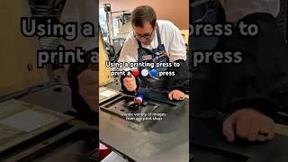 Using a printing press to print an image of a 🔴 ⚪️ 🔵 printing press