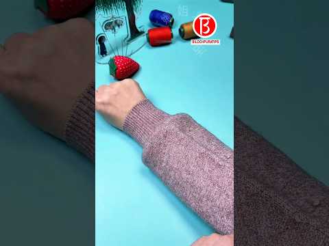 Cut the sleeves of the sweater off.