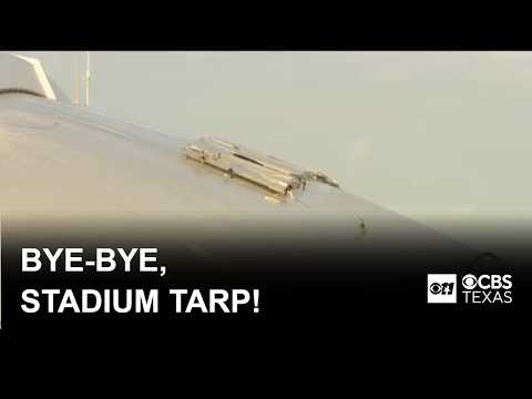 Workers remove tarp from AT&T Stadium logo after FIFA World Cup match