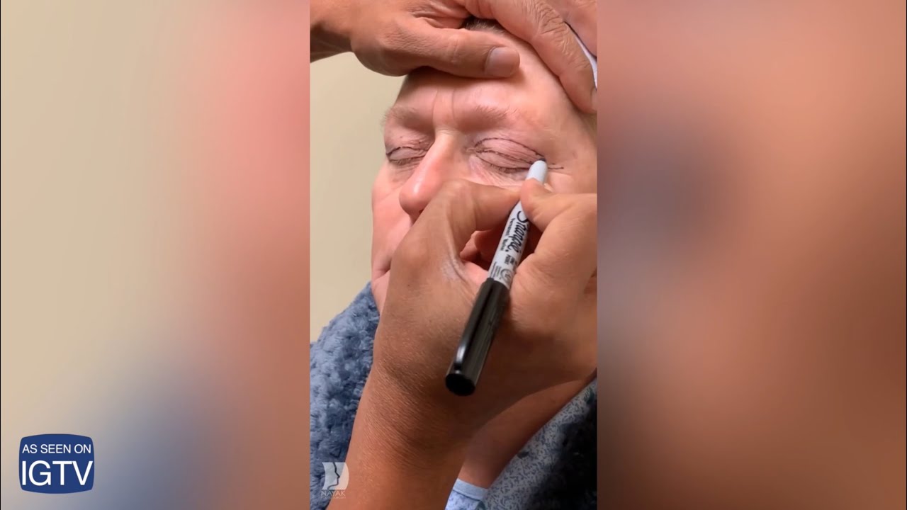 Applying eyeliner with precision on a client.