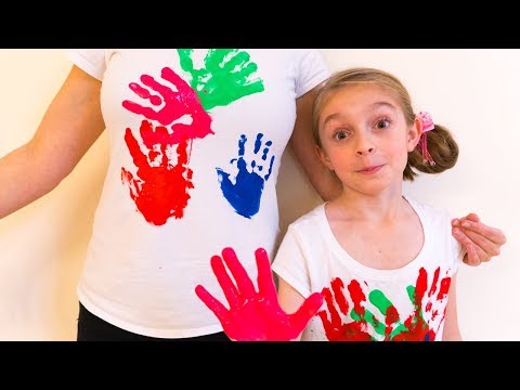 Alicia and Mom have funny play coloring T-shirts with their hands
