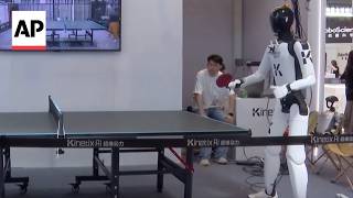 YouTube video thumbnail: World AI Conference: Humanoid Robots Play Table Tennis, do Laundry in China