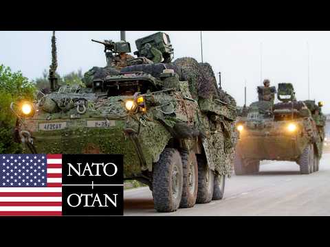 US Army, NATO. Armored vehicles cross a river during military exercises in Poland.