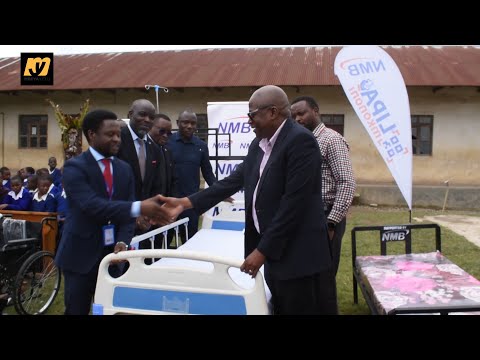 BENKI YA NMB YAMKABIDH DC HANIU MSAADA WA VIFAA VYA AFYA NA ELIMU VYA MIL 35