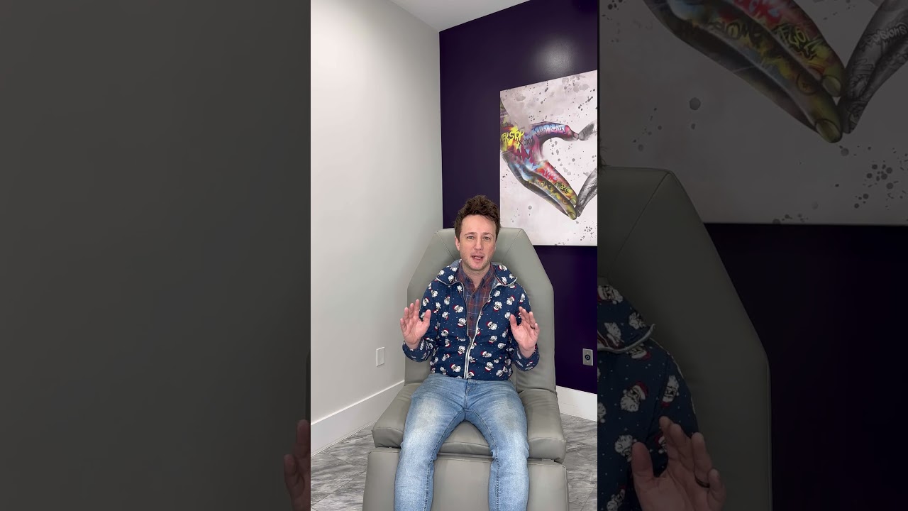 Person sitting in a chair, gesturing hands.