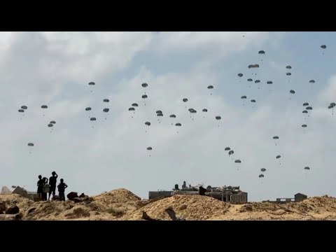 Parachutes fall during aid airdrop over the central Gaza Strip | AFP