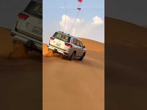 The flying Toyota Land Cruiser LC300 ZX v8 in dubai desert sand dune. affordable offroading SUV car.