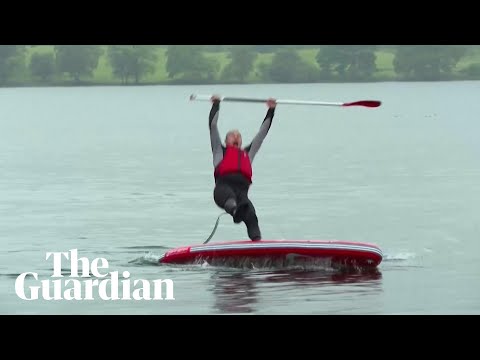 Liberal Democrat leader Ed Davey slips off paddleboard into lake