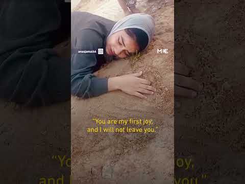 Palestinian girl cries at father’s grave, killed in Israeli air strike
