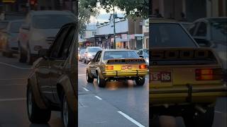 1980s Aussie street machine look for a Torana—complete with chrome mags and dropper exhaust pipes.