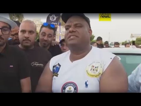 YouTube video thumbnail: Egyptian Wrestler Pulls 20 Cars in Bid for World Record