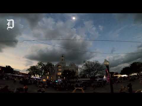 People cheer as the Hillsboro town square experiences totality during a solar eclipse