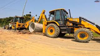 Two JCB 3dx backhoe digging Heavy concreat Hume pipe on Road