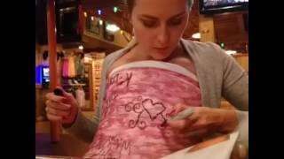 Hooters girls sign the pink camo body cast