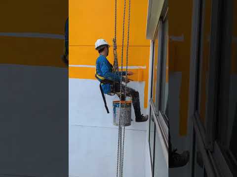 the process of painting high exterior walls using a safety rope #shorts