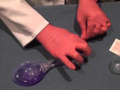 Hands using medical equipment for resuscitation.
