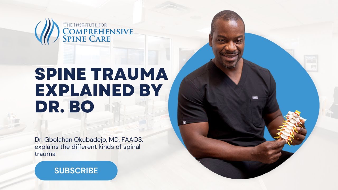 Doctor discussing spine trauma with model spine.