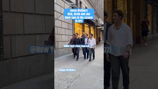 Jonas Brothers seen taking pictures with fans.