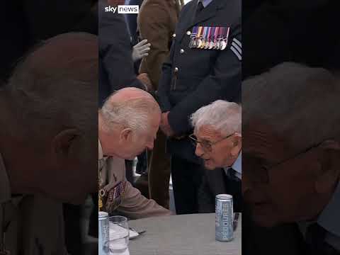 King Charles holds veteran’s hand