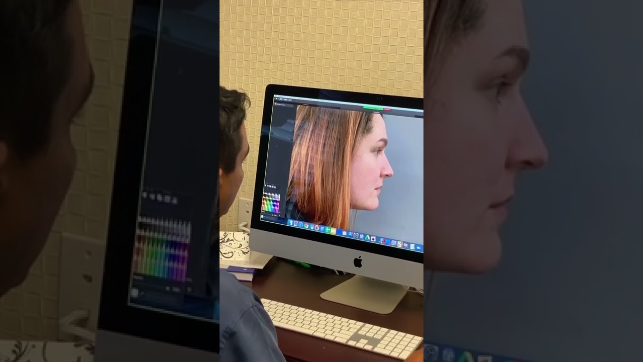 Person editing portrait on computer screen.