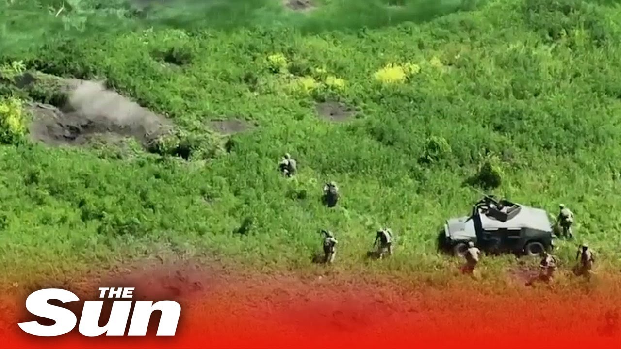 Ukrainian fighters storming Russian trenches in Humvee Vehicles