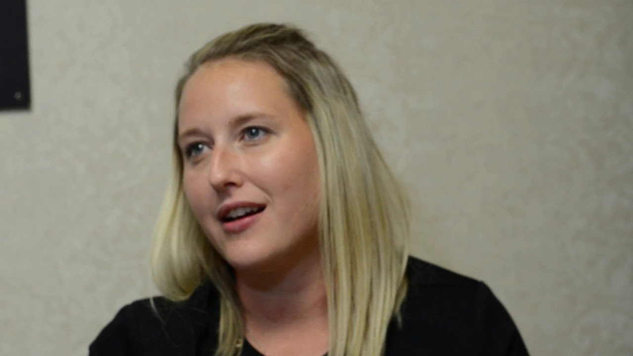 Woman speaking in a casual conversation setting.