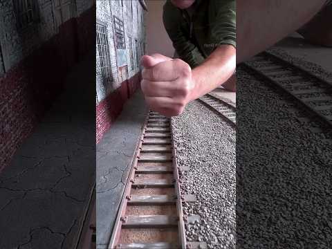 man makes mini railway station at house