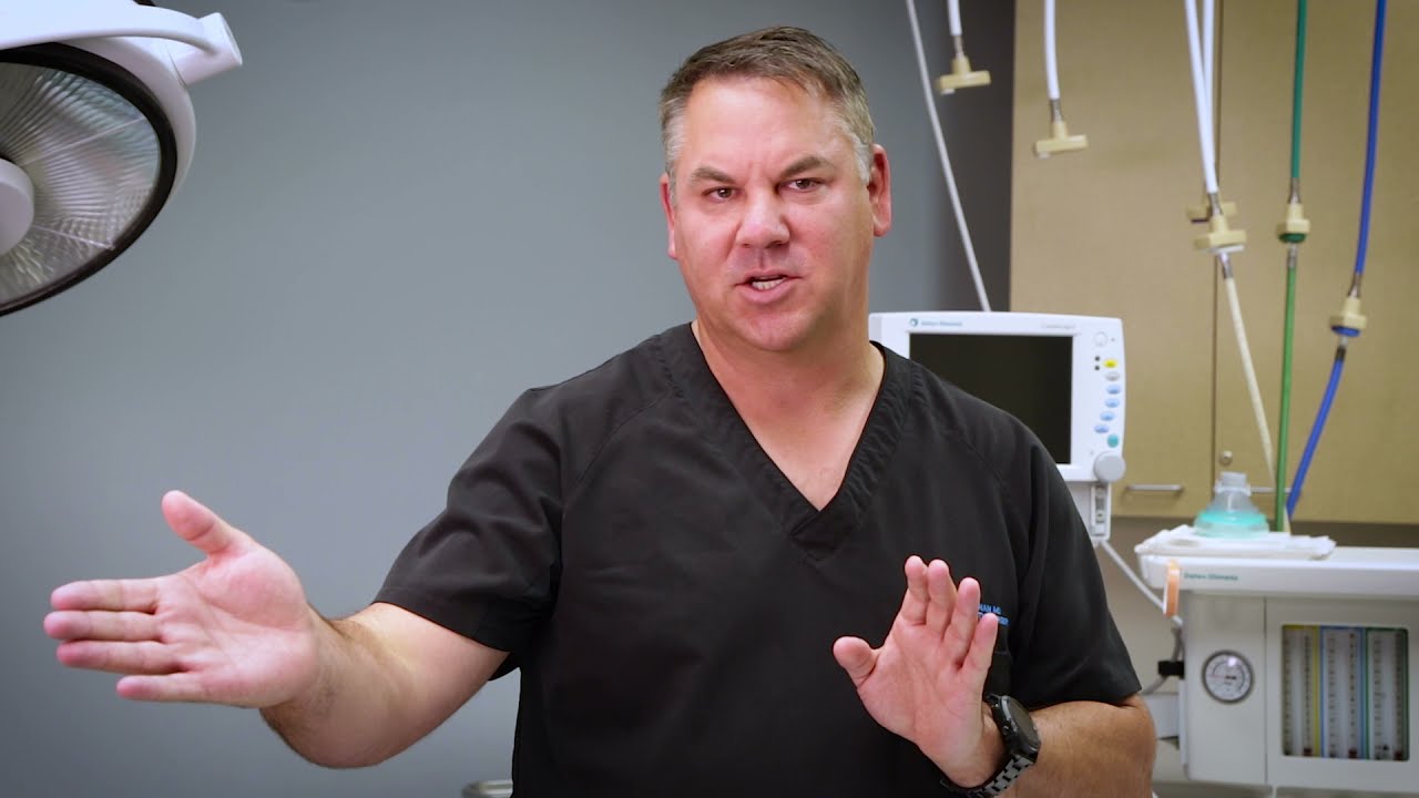Doctor explaining a procedure in a medical setting.