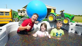 Playing in Orbeez and Crushing Tractor with Huge Water Balloon | Tractors for kids