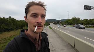 Smoking a Cigarette While Walking Next to a Highway in Brazil