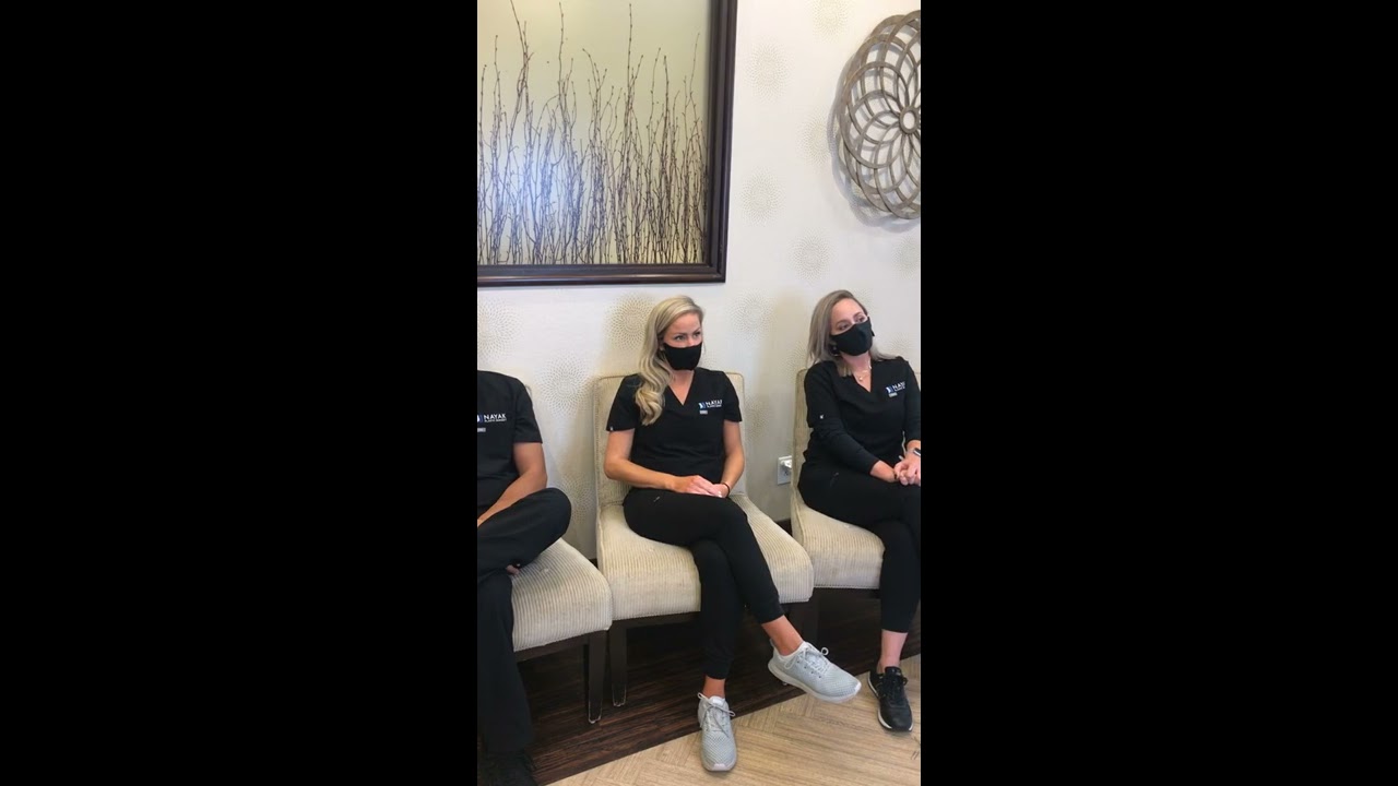 Healthcare professionals seated in waiting area.