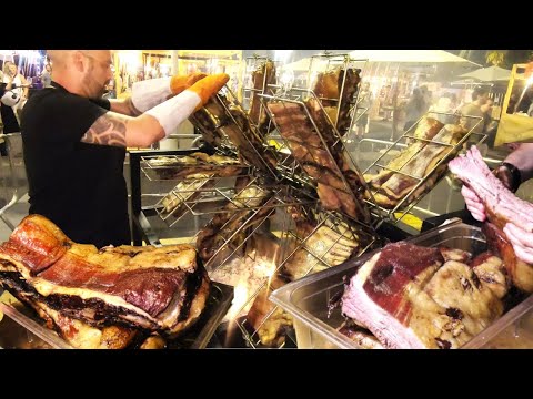 Rotary Machine Smoking Beef Ribs. Street Food in Barcelona, Spain. 'Meat & Fire' Fest