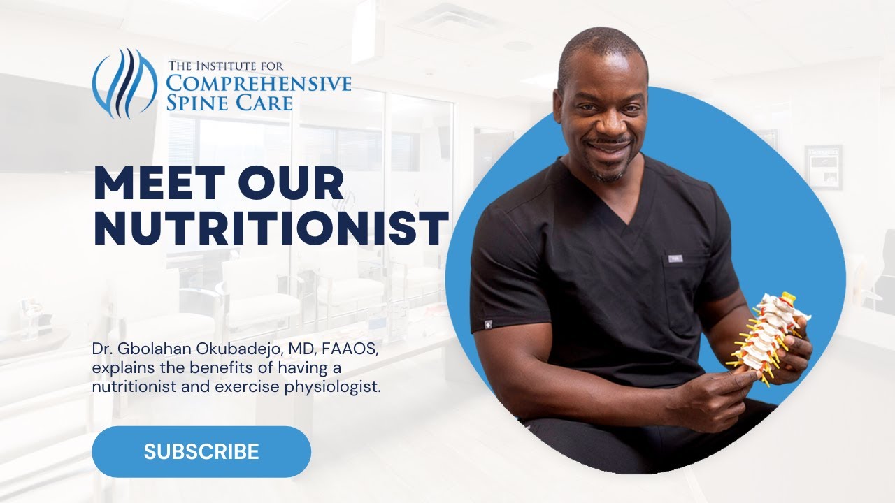 Nutritionist presenting spine model in clinic setting.