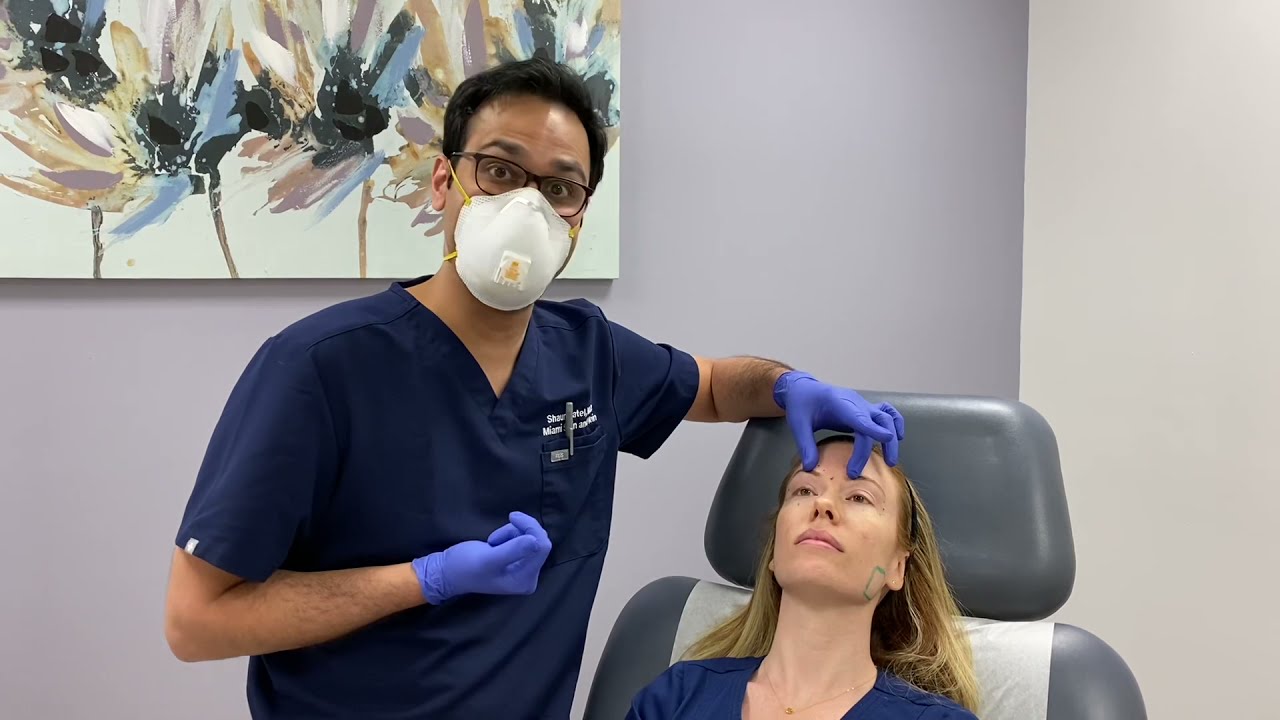 Woman with markings for cosmetic procedure preparation.