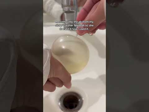 me removing the air from my sisterโs water NeeDoh so she doesnโt know i used it..
