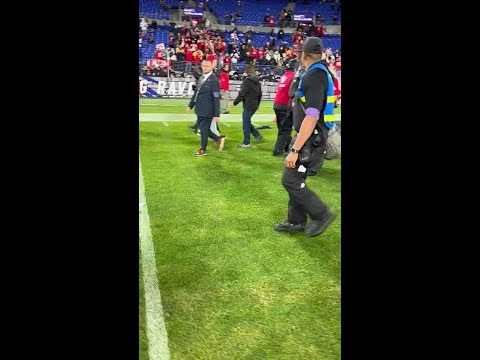 Taylor Swift walks on the field to congratulate Travis Kelce after the Chiefs AFC Championship win