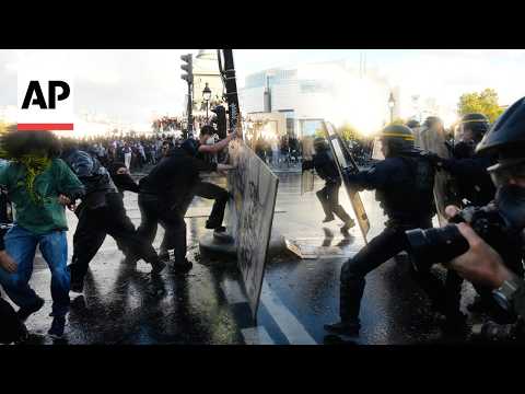 Police detain protesters in Paris as they moved in with tear gas