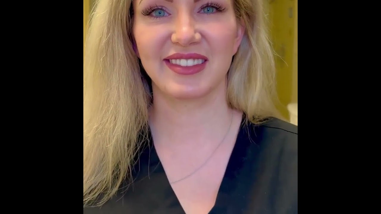 Smiling woman with blonde hair and professional attire.