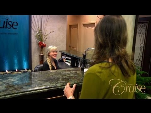 Receptionist welcoming a visitor at a clinic.
