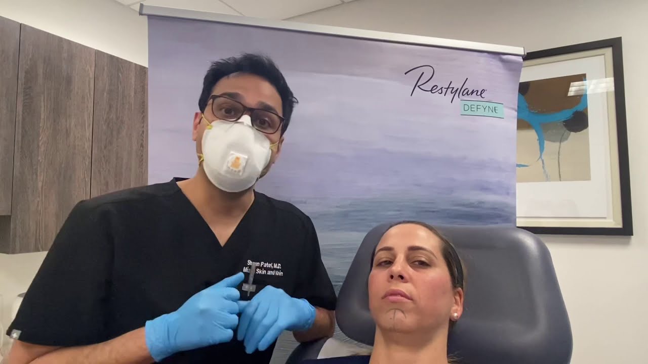 Woman with markings for cosmetic procedure preparation.