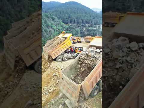 Dozens of heavy duty trucks unloading earthwork on site #infrastructure #mountains #technology