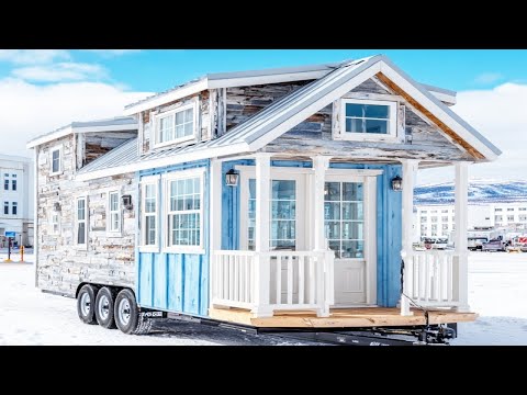 Stunning classy tiny house on wheels set in the snowy forest that everyone admires