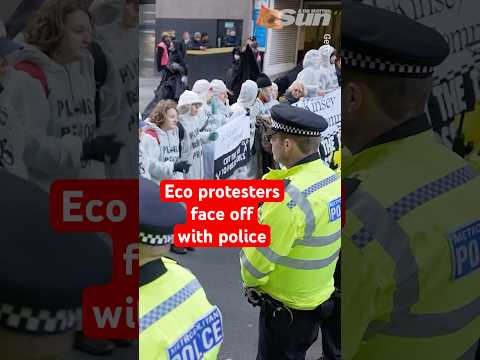 Extinction Rebellion protesters stop traffic as they confront police