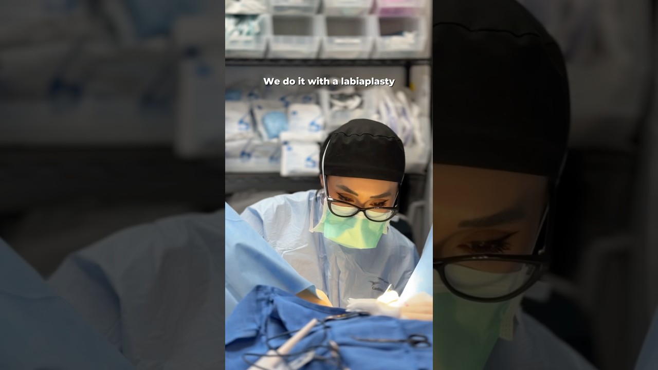 Surgeon performing labiaplasty procedure in clinic.