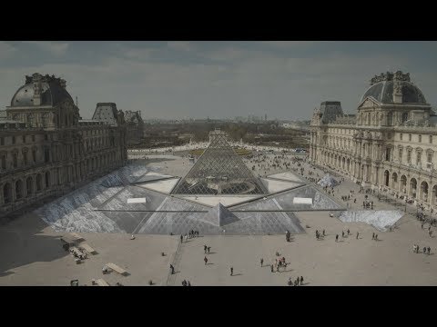 Watch JR construct a giant optical illusion around IM Pei's Louvre pyramid