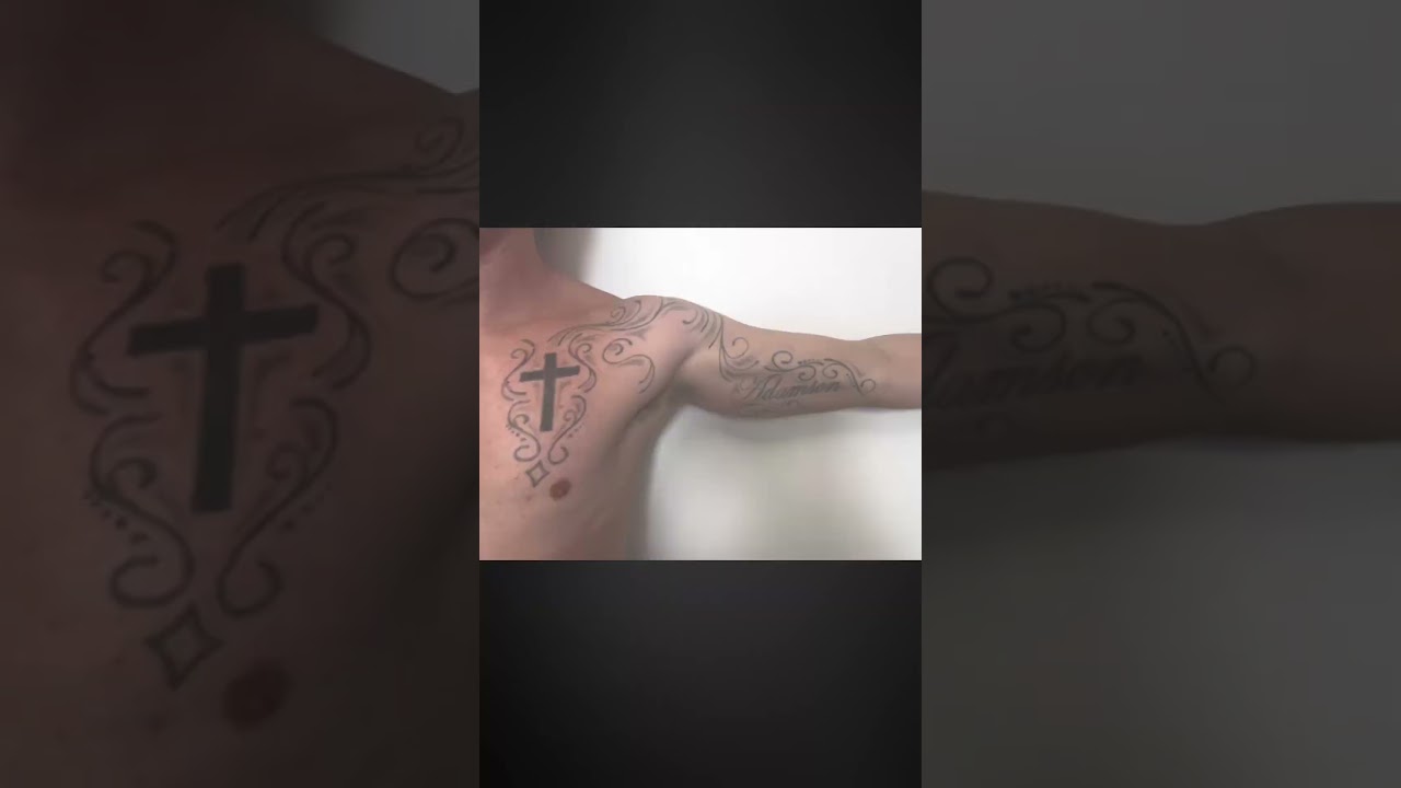 Tattoo of a cross and decorative designs.