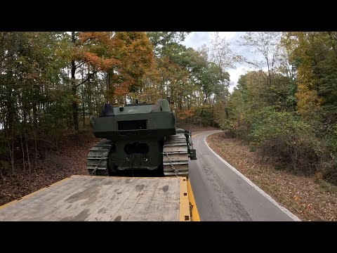 Peterbilt 389 with Cat C15 6NZ hauling a military dozer on dangerous curvy roads during the fall