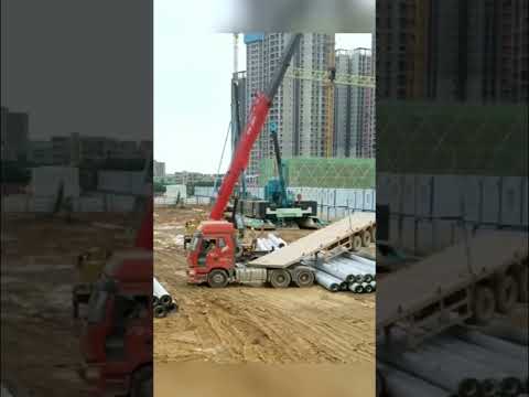 Crane helps truck to turn.