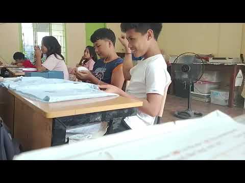 Boys sewing their pillow case