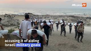 Palestinians carry bags of flour in northern Gaza Strip